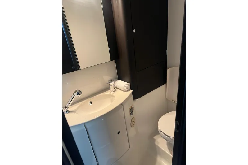 Queen Butterfly Yacht Photos Pics Compact bathroom in a 2006 Lagoon 440 yacht, featuring a sink and toilet.
