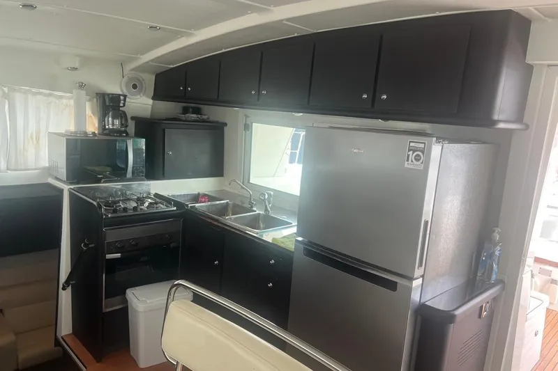 Queen Butterfly Yacht Photos Pics Interior of 2006 Lagoon 440 yacht kitchen with modern appliances and sleek cabinetry.