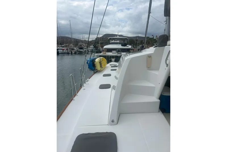 Queen Butterfly Yacht Photos Pics 2006 Lagoon 440 catamaran docked in a marina, featuring spacious deck and seating.