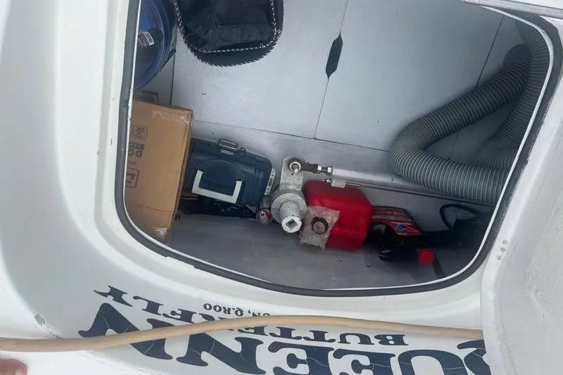 Queen Butterfly Yacht Photos Pics Storage compartment of a 2006 Lagoon 440 boat with various equipment and supplies.