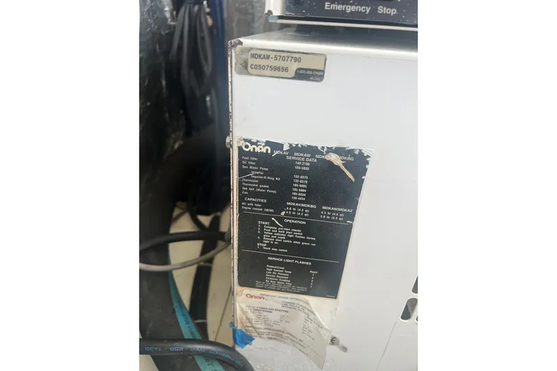 Queen Butterfly Yacht Photos Pics Onan generator panel on 2006 Lagoon 440 yacht, showing service data and operation instructions.