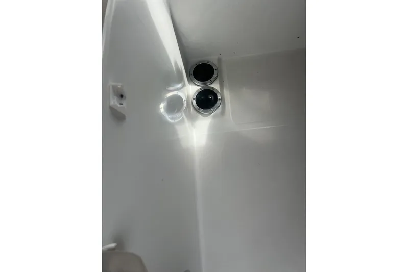 Queen Butterfly Yacht Photos Pics Interior view of 2006 Lagoon 440 yacht, featuring sleek white surfaces and circular fixtures.