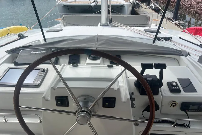 Queen Butterfly Yacht Photos Pics Helm of 2006 Lagoon 440 catamaran with navigation equipment and steering wheel.