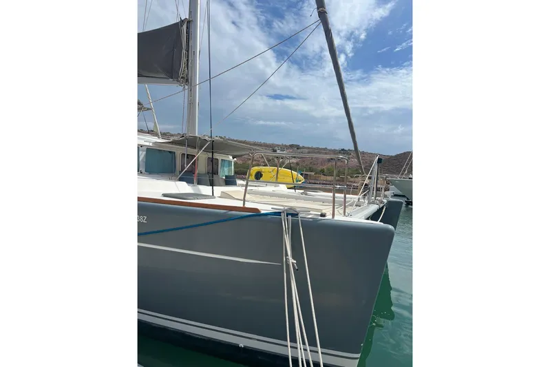 Queen Butterfly Yacht Photos Pics 2006 Lagoon 440 catamaran docked, featuring sleek design and spacious deck.