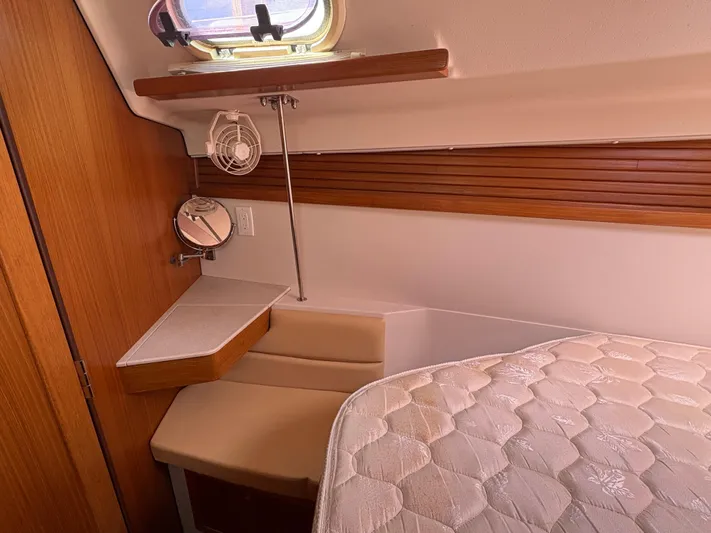 Carolina Wind Yacht Photos Pics 2011 Catalina 355 yacht interior with wooden paneling, small fan, and mattress.
