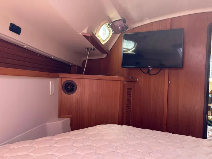 Carolina Wind Yacht Photos Pics Interior of 2011 Catalina 355 yacht cabin with TV and wooden paneling.