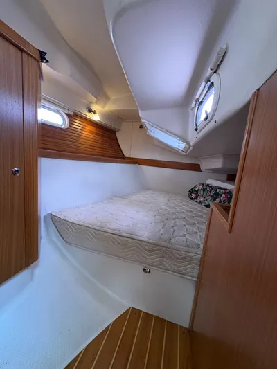 Carolina Wind Yacht Photos Pics Cozy cabin interior of 2011 Catalina 355 sailboat with wooden accents and mattress.