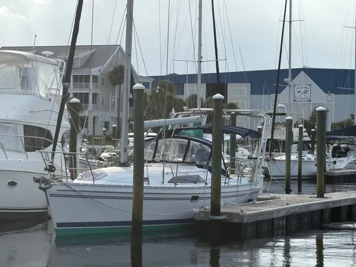 Carolina Wind Yacht Photos Pics 2011 Catalina 355 sailboat docked at marina with other boats and buildings in background.