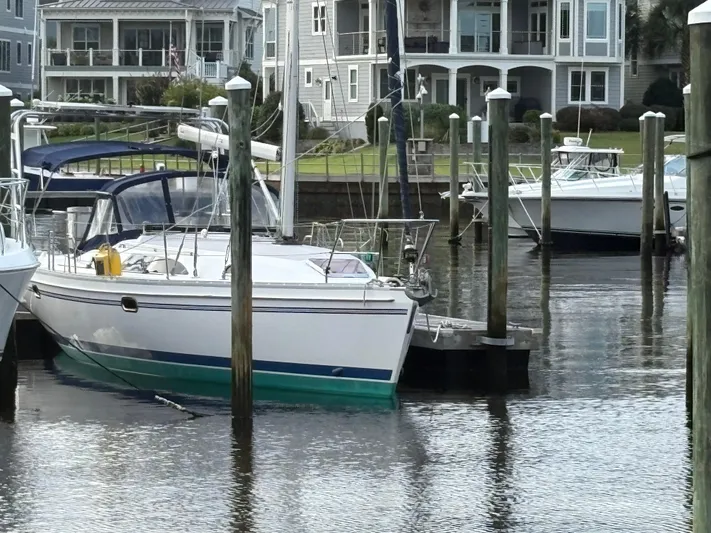 Carolina Wind Yacht Photos Pics Sailboat Catalina 355, 2011 model, docked in a marina with waterfront homes.