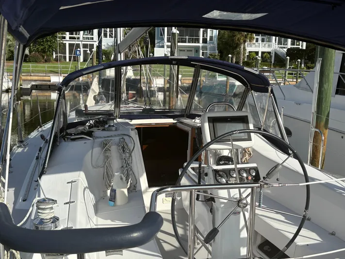 Carolina Wind Yacht Photos Pics Cockpit of a 2011 Catalina 355 sailboat with steering wheel and navigation equipment.
