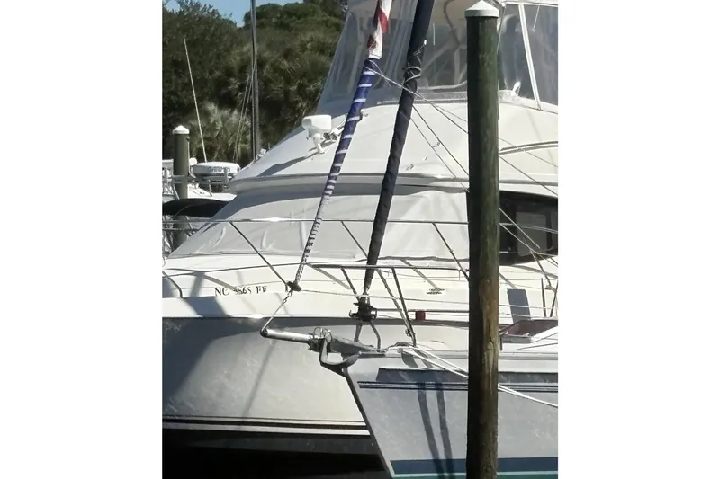 Carolina Wind Yacht Photos Pics 2011 Catalina 355 sailboat docked at a marina, partially obscured by a pole.