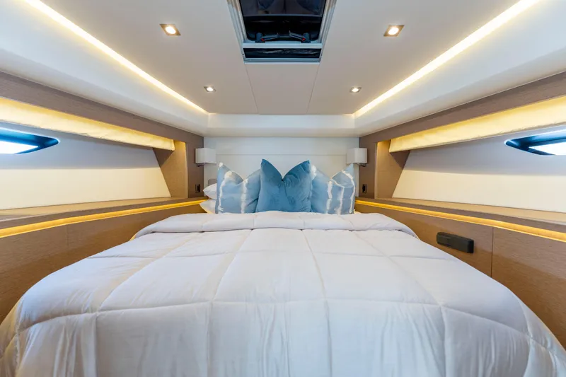 Seeworthy Yacht Photos Pics Luxurious bedroom interior of 2018 Prestige 560 yacht with elegant bedding and ambient lighting.
