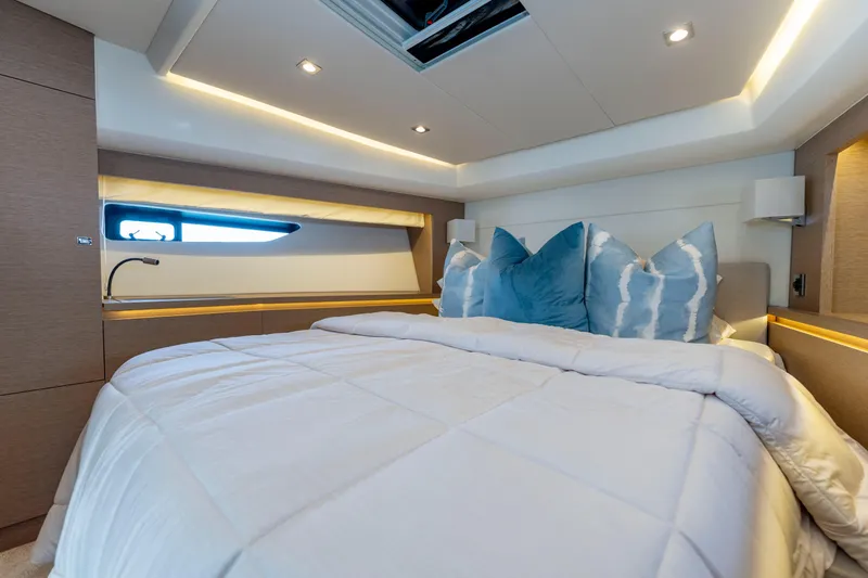 Seeworthy Yacht Photos Pics Luxurious bedroom interior of 2018 Prestige 560 yacht with modern lighting and plush bedding.