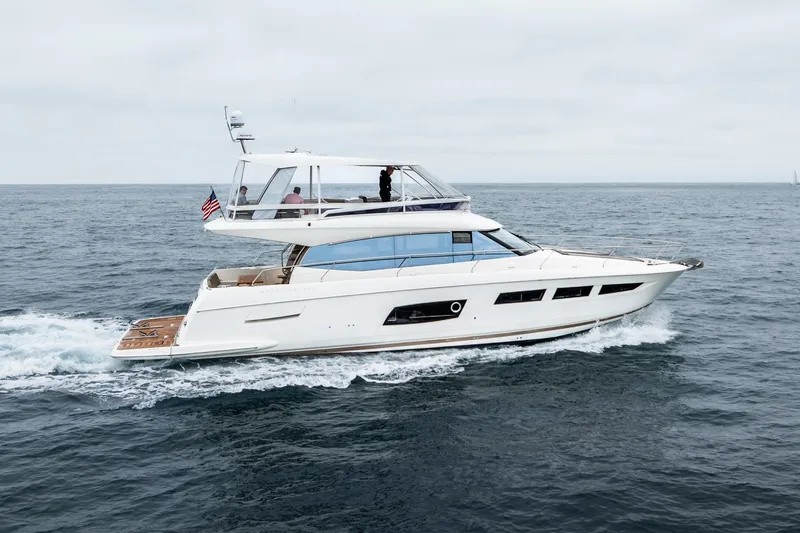 Seeworthy Yacht Photos Pics 2018 Prestige 560 yacht cruising on open sea under cloudy sky.