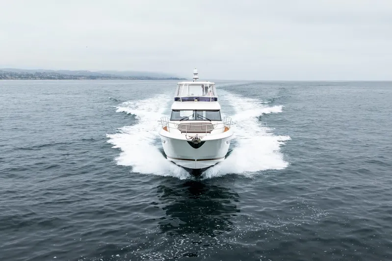 Seeworthy Yacht Photos Pics 2018 Prestige 560 yacht cruising on open sea, creating a dynamic water trail.