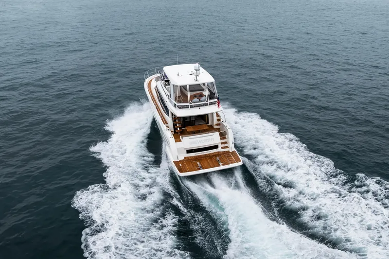 Seeworthy Yacht Photos Pics 2018 Prestige 560 yacht cruising on open sea, rear view, creating white wake.