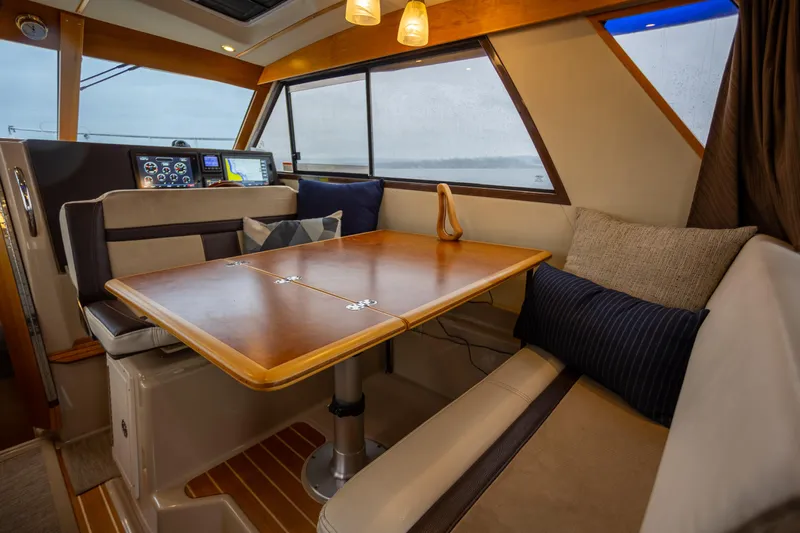 Halcyon Yacht Photos Pics Interior of 2016 Cutwater 30 CB boat with dining area and navigation controls.