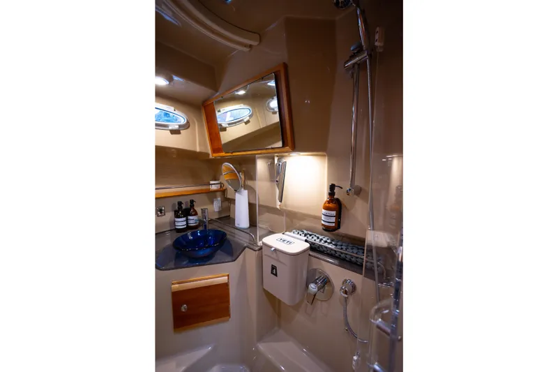 Halcyon Yacht Photos Pics Luxurious bathroom in 2016 Cutwater 30 CB yacht with modern fixtures and elegant design.