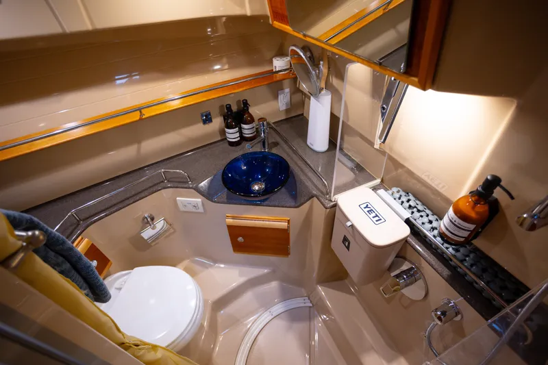 Halcyon Yacht Photos Pics Luxurious 2016 Cutwater 30 CB boat bathroom with modern amenities and elegant design.