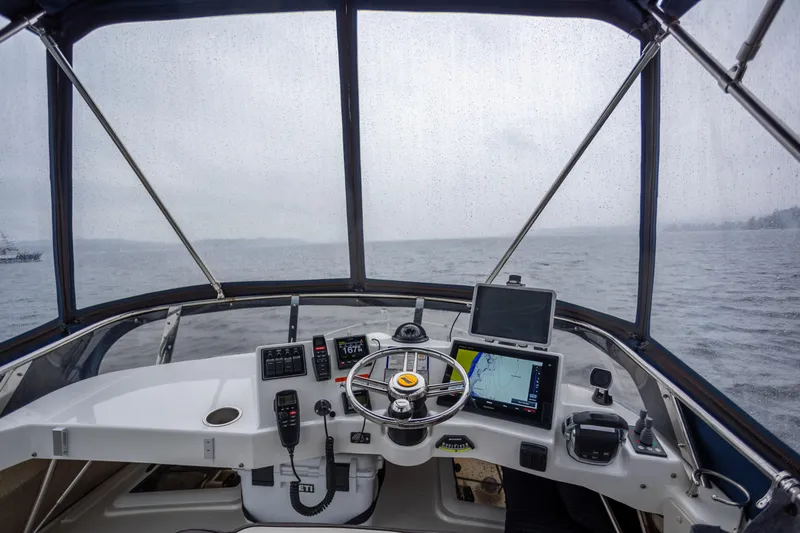 Halcyon Yacht Photos Pics Helm of 2016 Cutwater 30 CB boat with navigation equipment on a rainy day.