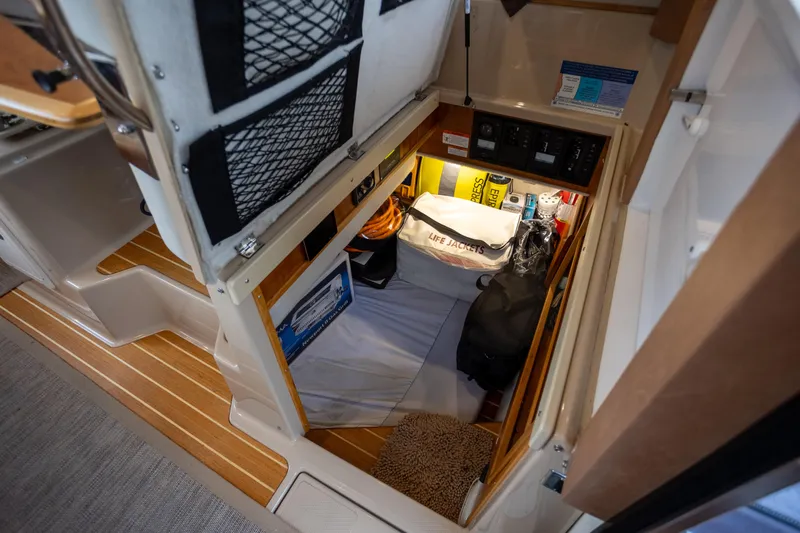 Halcyon Yacht Photos Pics 2016 Cutwater 30 CB interior storage with life jackets and equipment.
