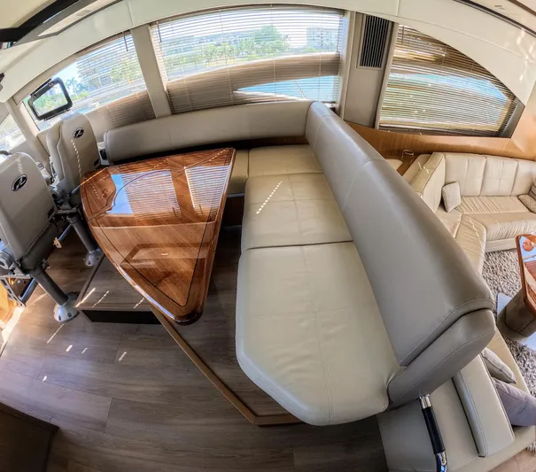  Yacht Photos Pics Luxurious interior of 2018 Sea Ray L590 yacht with leather seating and wooden table.