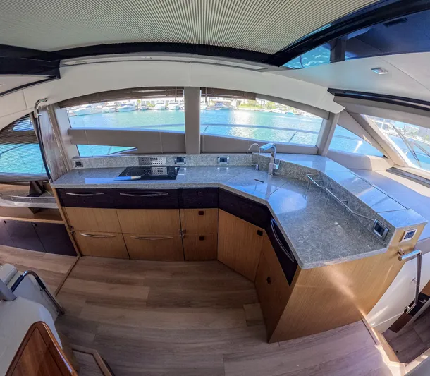  Yacht Photos Pics Luxurious kitchen interior of 2018 Sea Ray L590 yacht with modern countertops and scenic window views.