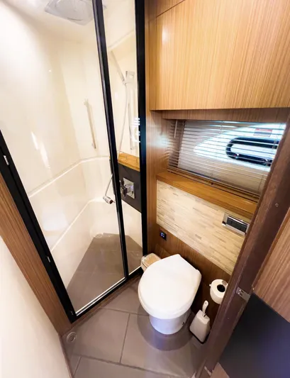  Yacht Photos Pics Luxurious bathroom in 2018 Sea Ray L590 yacht with modern shower and wooden accents.