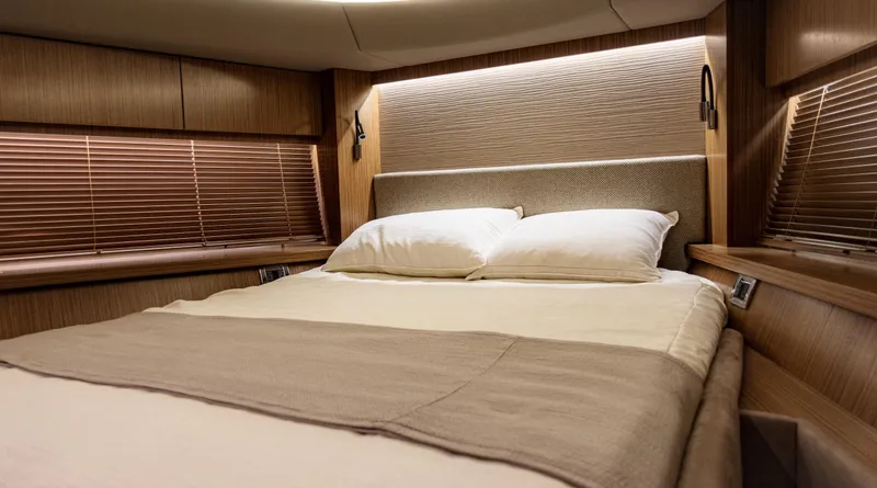  Yacht Photos Pics Luxurious bedroom interior of 2018 Sea Ray L590 yacht with elegant wood finishes.