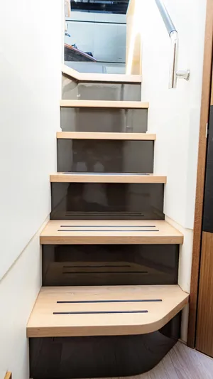  Yacht Photos Pics Staircase inside 2018 Sea Ray L590 yacht, featuring sleek wooden steps and modern design.