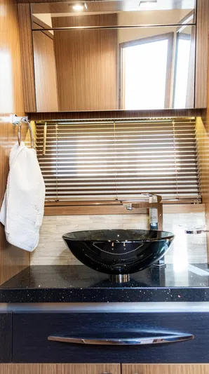  Yacht Photos Pics Luxurious bathroom interior of 2018 Sea Ray L590 yacht with modern sink and wooden accents.