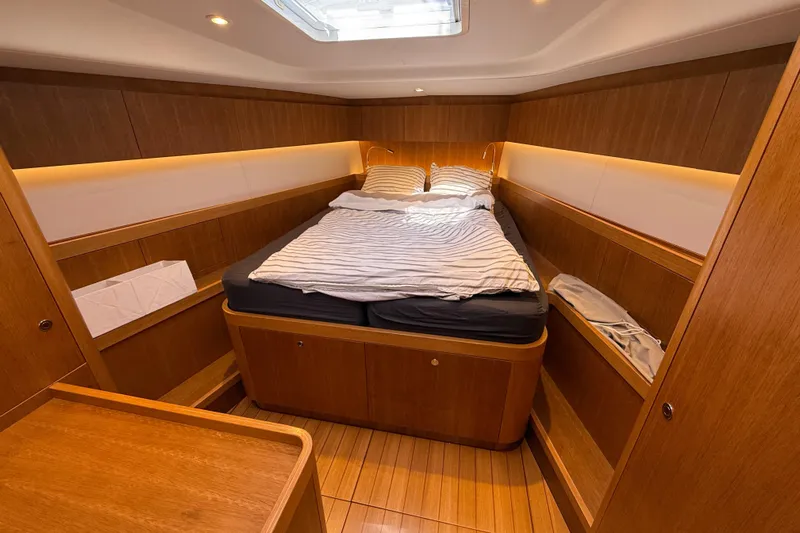 Pau Hana Yacht Photos Pics Luxurious cabin interior of 2019 Nautor Swan 54 yacht with wooden finish and cozy bed.