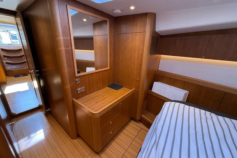 Pau Hana Yacht Photos Pics Luxurious wooden interior of 2019 Nautor Swan 54 yacht cabin with bed and mirror.
