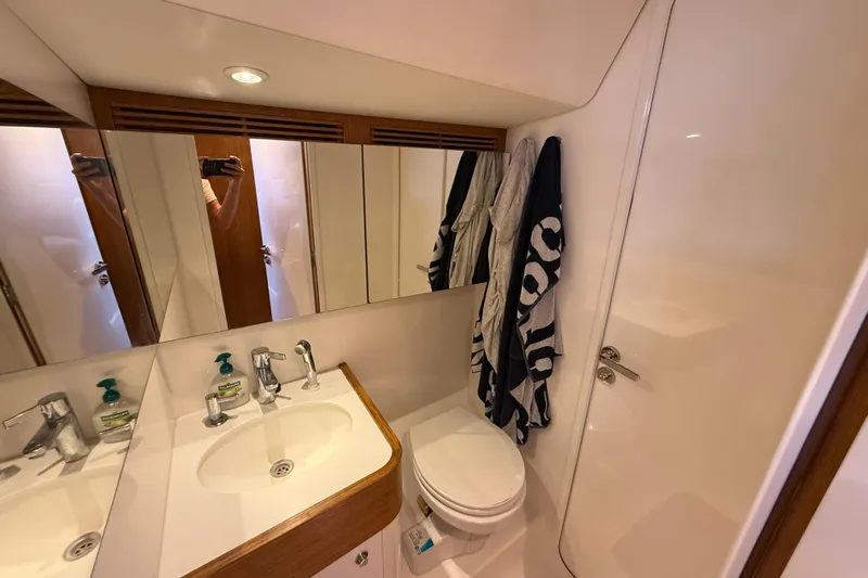 Pau Hana Yacht Photos Pics Luxurious bathroom in 2019 Nautor Swan 54 yacht with modern fixtures and elegant design.