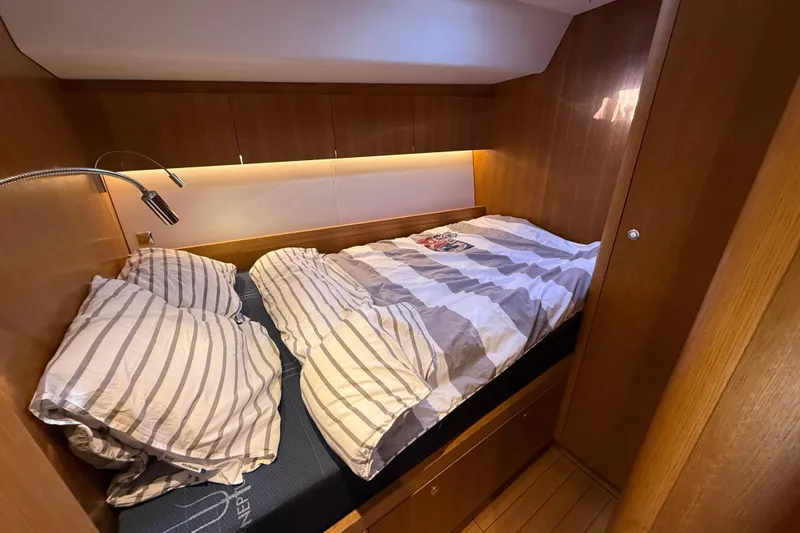Pau Hana Yacht Photos Pics Cozy cabin bedroom in 2019 Nautor Swan 54 yacht with striped bedding.