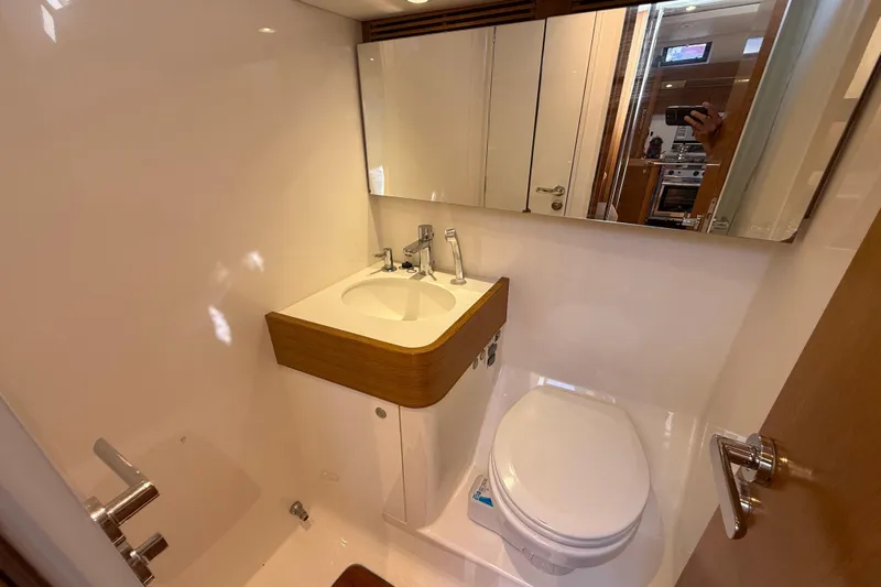 Pau Hana Yacht Photos Pics Bathroom interior of 2019 Nautor Swan 54 yacht, featuring sink and toilet.