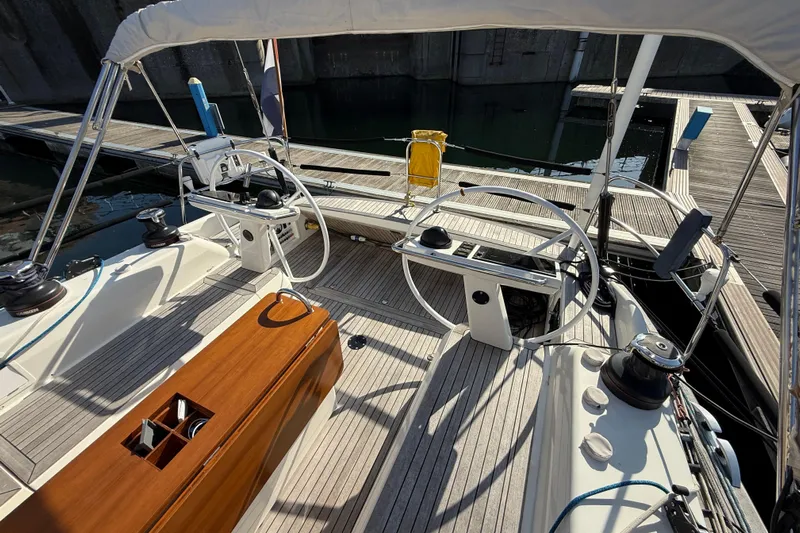 Pau Hana Yacht Photos Pics Cockpit of 2019 Nautor Swan 54 yacht with dual steering wheels and wooden deck.