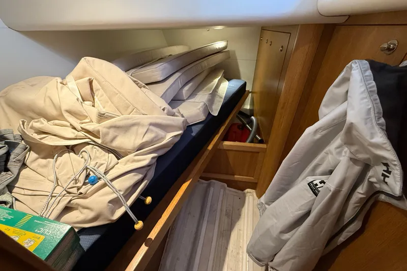 Pau Hana Yacht Photos Pics Cozy cabin interior of 2019 Nautor Swan 54 yacht with storage and hanging jacket.