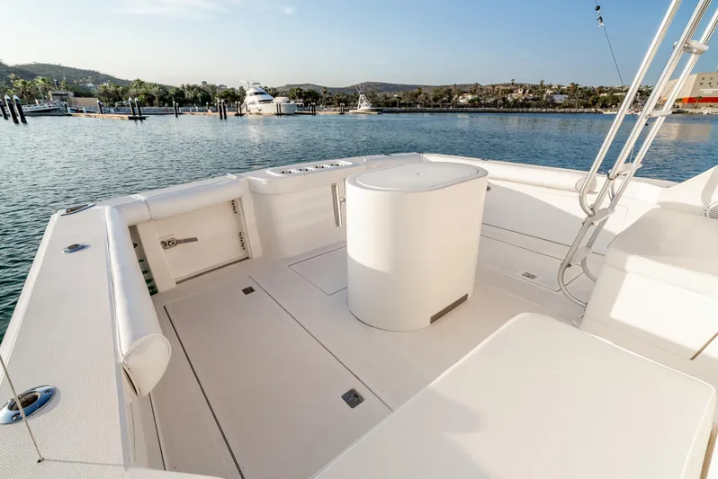 More Good Yacht Photos Pics Spacious deck of 2002 Cabo 35 Flybridge yacht in a serene marina setting.