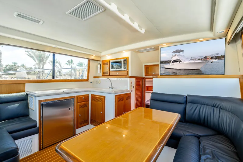 More Good Yacht Photos Pics Luxurious interior of 2002 Cabo 35 Flybridge yacht with modern amenities and elegant seating.
