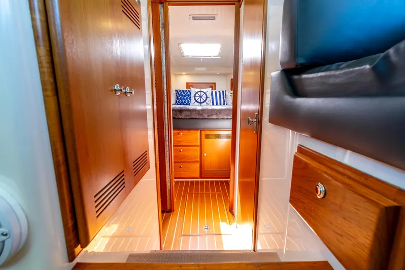 More Good Yacht Photos Pics Interior of 2002 Cabo 35 Flybridge yacht with wooden cabinetry and nautical-themed decor.