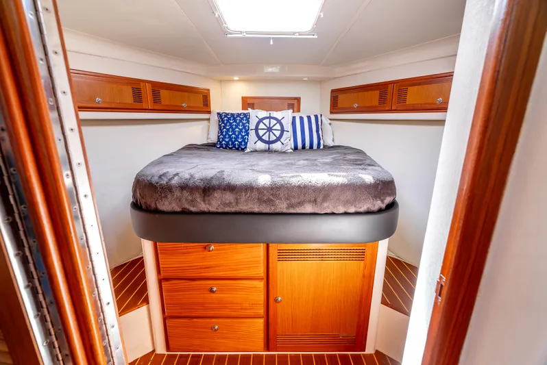 More Good Yacht Photos Pics Luxurious cabin interior of 2002 Cabo 35 Flybridge with nautical-themed decor.