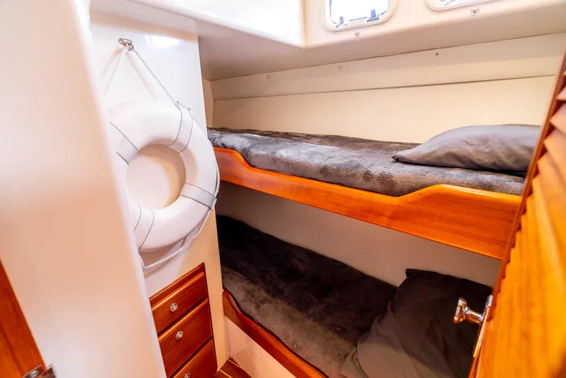 More Good Yacht Photos Pics Cozy bunk beds in 2002 Cabo 35 Flybridge cabin with life preserver.