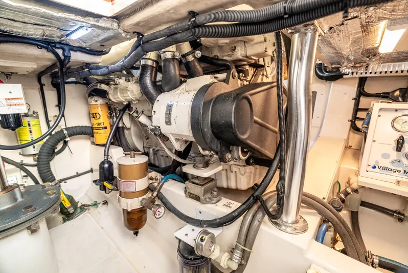 More Good Yacht Photos Pics Engine room of 2002 Cabo 35 Flybridge boat, showcasing mechanical components and wiring.