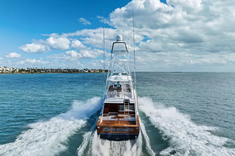 Knot Haulin Yacht Photos Pics 2017 Spencer Convertible yacht cruising on open water under a partly cloudy sky.