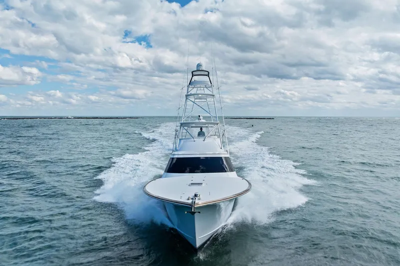 Knot Haulin Yacht Photos Pics 2017 Spencer Convertible yacht cruising on open water under a cloudy sky.
