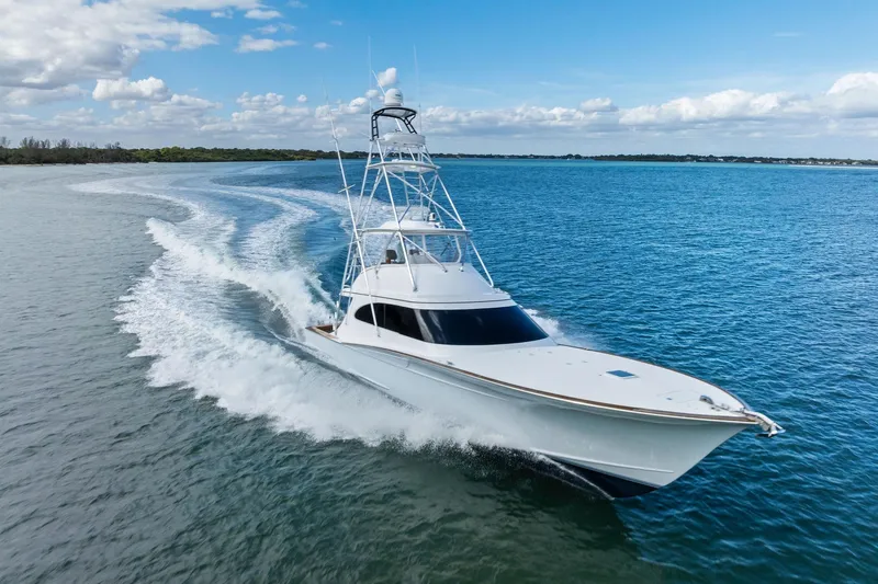 Knot Haulin Yacht Photos Pics 2017 Spencer Convertible yacht cruising on open water under a clear blue sky.