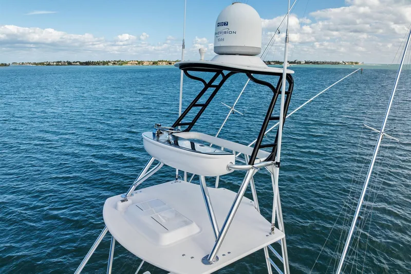 Knot Haulin Yacht Photos Pics 2017 Spencer Convertible yacht tower with radar, overlooking calm blue ocean and distant shoreline.
