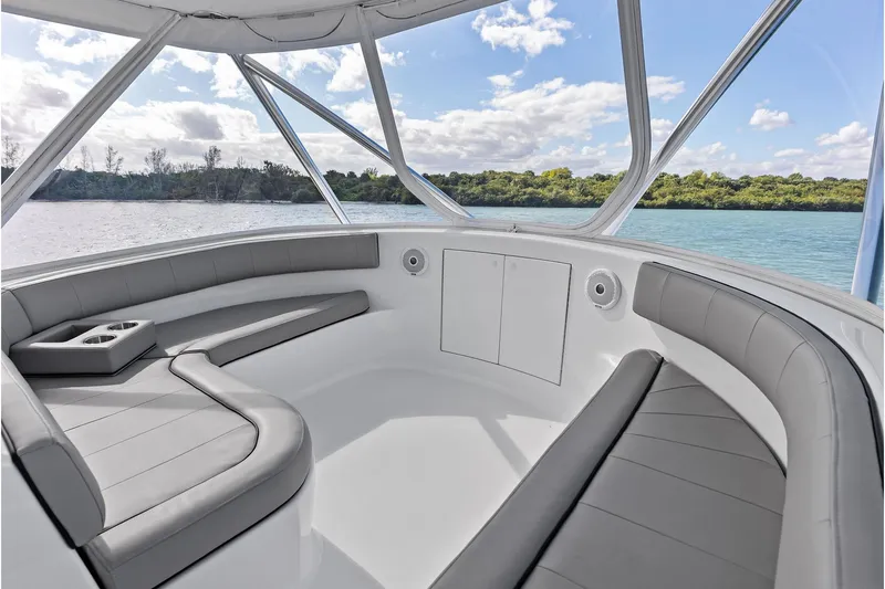 Knot Haulin Yacht Photos Pics 2017 Spencer Convertible boat interior with gray seating, cup holders, and scenic water view.