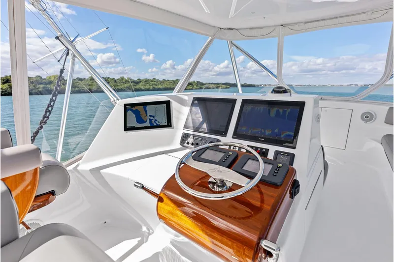 Knot Haulin Yacht Photos Pics 2017 Spencer Convertible yacht helm with navigation screens and wooden steering wheel.